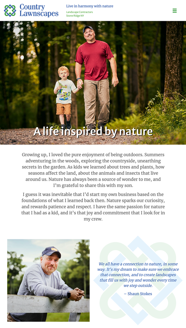 A father holds his son's hand as they walk through the woods.