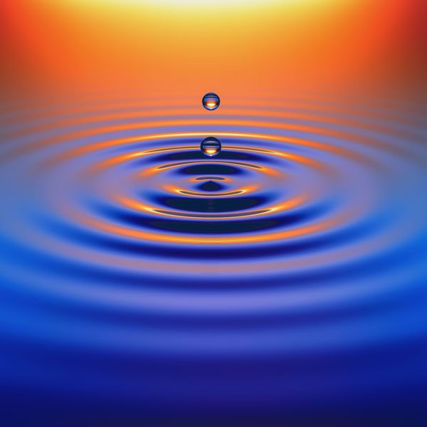 Water drops create ripples at sunset